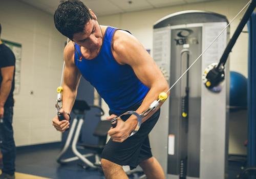 Student training arms in gym